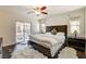 Bright main bedroom features a decorative ceiling fan, and a sliding glass door at 3839 Zodiacal Light St, Las Vegas, NV 89129