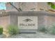 Decorative stone sign in a brick surround welcomes visitors to the Hillside community at 3839 Zodiacal Light St, Las Vegas, NV 89129