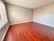 An open bedroom offers wood-like floors and window blinds for natural light at 4331 Sanderling Cir # 46, Las Vegas, NV 89103