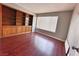 Bedroom featuring a wall of built-in shelves, a large window, and hardwood floors with natural light at 4331 Sanderling Cir # 46, Las Vegas, NV 89103
