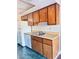 Practical kitchen featuring a white refrigerator, light wood cabinetry, a stainless sink and counter space at 4331 Sanderling Cir # 46, Las Vegas, NV 89103