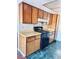 The kitchen features practical appliances and wood cabinetry with a black gas range and range hood at 4331 Sanderling Cir # 46, Las Vegas, NV 89103