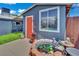 Cozy backyard shed with window, door, brick-lined fishpond, and manicured artificial turf at 4419 Lorna Pl, Las Vegas, NV 89107