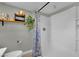 Updated bathroom with tiled floors, new shower fixture and stylish blue and white shower curtain at 4419 Lorna Pl, Las Vegas, NV 89107
