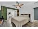 Comfortable bedroom with ceiling fan, wood-style floors, and serene decor at 4419 Lorna Pl, Las Vegas, NV 89107
