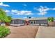 Charming single-story home with a well-manicured yard and an inviting orange front door at 4419 Lorna Pl, Las Vegas, NV 89107
