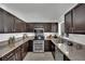 Well-lit kitchen featuring stainless steel appliances, dark cabinetry, and stylish countertops for a modern look at 4419 Lorna Pl, Las Vegas, NV 89107