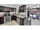 A functional kitchen with dark wood cabinets, modern appliances, and a view of the backyard at 4419 Lorna Pl, Las Vegas, NV 89107