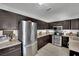 Bright kitchen with stainless steel appliances, dark wood cabinets, and neutral countertops at 4419 Lorna Pl, Las Vegas, NV 89107