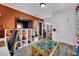 Spacious playroom featuring a TV, shelving for storage, a work table, and tile floor at 4419 Lorna Pl, Las Vegas, NV 89107