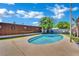 Private backyard pool with a cozy hammock and chairs amidst green artificial grass, offering relaxation and fun at 4419 Lorna Pl, Las Vegas, NV 89107