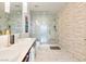 Bathroom boasts double sinks, marble countertops, and a walk-in shower with gray and white tiling at 4471 Dean Martin Dr # 1109, Las Vegas, NV 89103