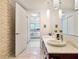 Bathroom boasts double sinks, marble countertops, and an open-concept shower with brick accent wall at 4471 Dean Martin Dr # 1109, Las Vegas, NV 89103