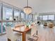 Bright dining area with a modern chandelier and floor-to-ceiling windows showcasing panoramic city views at 4471 Dean Martin Dr # 1109, Las Vegas, NV 89103