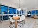 Dining area with modern table and chairs, chandelier, and stunning cityscape views at 4471 Dean Martin Dr # 1109, Las Vegas, NV 89103