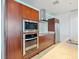 Gourmet kitchen with stainless steel microwave, oven, cherry wood cabinets and solid surface countertops at 4471 Dean Martin Dr # 1109, Las Vegas, NV 89103