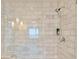 Modern walk-in shower featuring gray and white tiling, a handheld shower head, and built-in shelving at 4471 Dean Martin Dr # 1109, Las Vegas, NV 89103