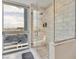 Modern walk-in shower with gray and white tiling, a city view, handheld shower head and built-in shelving at 4471 Dean Martin Dr # 1109, Las Vegas, NV 89103