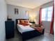 Serene bedroom with a cozy bed, modern decor, and natural light from the window at 4682 Leeann Ln, Las Vegas, NV 89121
