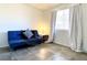 Simple bedroom featuring a blue futon, neutral curtains, and ample natural light at 4682 Leeann Ln, Las Vegas, NV 89121