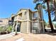 A two-story condo featuring an external staircase and lush landscaping around its perimeter at 4682 Leeann Ln, Las Vegas, NV 89121