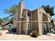 View of a two-story condo building, showcasing its exterior with a blue garage visible in the distance at 4682 Leeann Ln, Las Vegas, NV 89121