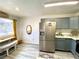Bright kitchen with stainless steel refrigerator, gray cabinets, and a functional layout at 4682 Leeann Ln, Las Vegas, NV 89121