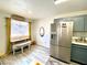 Bright kitchen featuring stainless steel refrigerator, a breakfast nook, and gray cabinets at 4682 Leeann Ln, Las Vegas, NV 89121