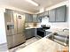 Functional kitchen with gray cabinets, stainless steel refrigerator, and modern appliances at 4682 Leeann Ln, Las Vegas, NV 89121