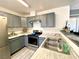 Modern kitchen featuring gray cabinets, stainless steel appliances, and ample counter space at 4682 Leeann Ln, Las Vegas, NV 89121