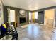 Open living room showcasing a fireplace and tile floors with an adjacent laundry room at 4682 Leeann Ln, Las Vegas, NV 89121