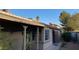 The backyard has a covered patio, desert landscaping, and block wall fencing at 5353 Hollow Brook Ave, Las Vegas, NV 89142