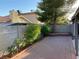 Private backyard patio area with block wall, shrubs, and a shade tree at 5353 Hollow Brook Ave, Las Vegas, NV 89142