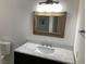 Bright bathroom featuring a modern vanity with light wood framed mirror at 5353 Hollow Brook Ave, Las Vegas, NV 89142