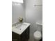Well-lit powder room featuring modern vanity, white toilet, and neutral paint at 5353 Hollow Brook Ave, Las Vegas, NV 89142