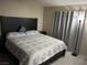 Tastefully decorated bedroom with soft lighting, dark wood furniture, and tile floor at 5353 Hollow Brook Ave, Las Vegas, NV 89142