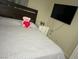 Cozy bedroom featuring a plush bed, teddy bear, and a mounted television at 5353 Hollow Brook Ave, Las Vegas, NV 89142