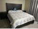 Nicely appointed bedroom with a dark wood bed frame, and tile flooring at 5353 Hollow Brook Ave, Las Vegas, NV 89142