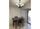 Dining area with a dark wood table and chandelier at 5353 Hollow Brook Ave, Las Vegas, NV 89142
