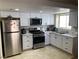 Modern kitchen with stainless steel appliances, white cabinets, and tile backsplash at 5353 Hollow Brook Ave, Las Vegas, NV 89142