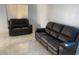 Living room featuring tiled floors and two leather reclining sofas at 5353 Hollow Brook Ave, Las Vegas, NV 89142