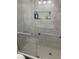 Modern tiled shower features glass door, a tiled niche, and grab bars for added safety at 5353 Hollow Brook Ave, Las Vegas, NV 89142