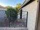 Charming side yard with decorative metal gate and lush landscaping at 5353 Hollow Brook Ave, Las Vegas, NV 89142