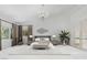 This staged main bedroom offers a calm palette with neutral color and lots of natural light at 5405 San Bellasera Ct, Las Vegas, NV 89141