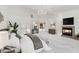 Relax in the staged primary suite, which features a fireplace, sitting area, and beautiful chandelier at 5405 San Bellasera Ct, Las Vegas, NV 89141