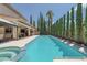 Enjoy the refreshing swimming pool with a spa, surrounded by lush greenery and ample patio space for lounging at 5405 San Bellasera Ct, Las Vegas, NV 89141