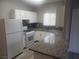 Bright kitchen with granite countertops, white appliances and cabinets, plus new gray flooring at 5655 E Sahara Ave # 2068, Las Vegas, NV 89142