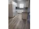 The kitchen has granite countertops and new gray flooring at 5655 E Sahara Ave # 2068, Las Vegas, NV 89142