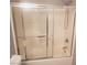 Shower with sliding glass doors and white tile surround at 5655 E Sahara Ave # 2068, Las Vegas, NV 89142