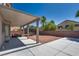 Backyard featuring a covered patio, outdoor seating, a trampoline, and desert landscaping at 5712 French Lace Ct, North Las Vegas, NV 89081
